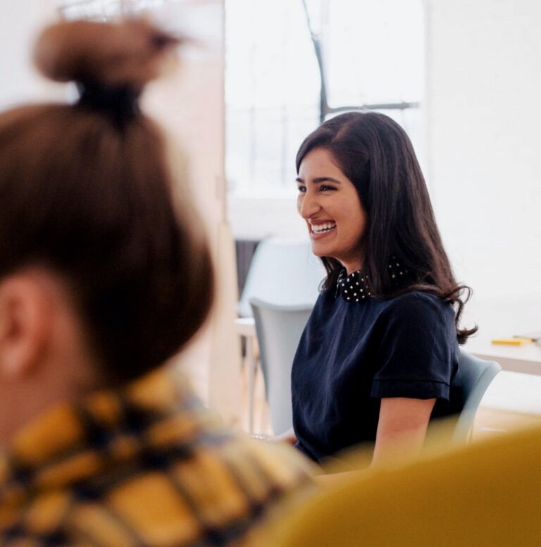 Two colleagues, one laughing. Free KYC API & AML tools Startup program
