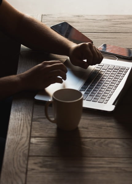 Photo of a person working on a laptop. Money laundering reporting officer (MLRO)